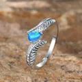Elegant silver feather ring featuring a teardrop-shaped blue opal gemstone inlay - US 6 / Platinum Blue Opal