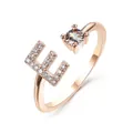 Adjustable rose gold letter E ring featuring pavé rhinestones and a sparkling crystal - Letter E / Rose Gold