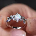 Elegant silver leaf ring with round white opal and sparkling cubic zirconia stones - US 6 / White