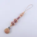 Detail of baby pacifier clip with natural beech wood rings and purple silicone beads - Dark Mauve