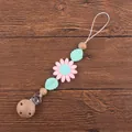 Close-up of beech wood pacifier clip with pink silicone sunflower and green leaves - Pink