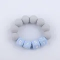 Macro detail of silicone baby teether bracelet with grey beads and blue BABY letters - Light Gray