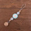 Detail of baby pacifier clip featuring a light blue silicone daisy and smooth beech wood beads - Blue
