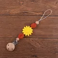 Detail of baby pacifier clip with yellow sunflower silicone beads and beech wood clip - Yellow