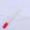 Close-up of baby pacifier clip with red plastic clasp and round cream pearl beads - Red