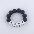Detail of baby teething bracelet with black silicone beads and white BABY letter cubes - Black