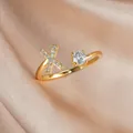 Adjustable golden ring with letter X design and sparkling zircon on silk background - Letter X / Gold