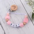 Detail of pink silicone beads and wooden clip with rainbow engraving for baby pacifier - Pink