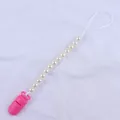 Close-up of pink plastic clip and white faux pearl beads on a baby pacifier chain - Rose Red