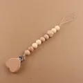 Detail of baby pacifier clip with beech wood heart clamp and cream silicone beads - Light Skin