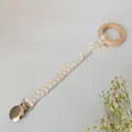 Detail of handmade braided cotton pacifier clip with natural wood ring and metal clasp - 2#