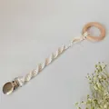Detail of handmade macrame pacifier clip with natural wood ring and cotton rope - Spiral Weave Style (1#)