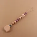 Detail of wooden heart clip and silicone beads on a handmade baby pacifier chain - Dark Mauve