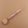Detail of wooden heart clip and purple silicone beads on a natural baby pacifier chain - Light Purple