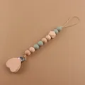 Detail of baby pacifier clip with beech wood heart clamp and green silicone beads - Sage Green