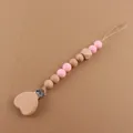 Detail of baby pacifier clip with heart wooden clasp and pink silicone beads - Pink