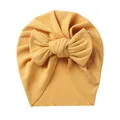 Detailed texture of ginger yellow ribbed baby turban hat with a large bow decoration - Yellow