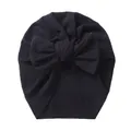 Detailed close-up of ribbed fabric texture and large bow on baby turban hat - Black