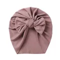 Close-up of baby turban hat featuring mauve ribbed knit fabric and large bow detail - Dusty Pink