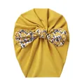 Detail of baby turban hat in mustard yellow with floral bow in soft jersey knit - Yellow Floral