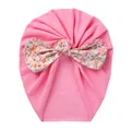 Detail of baby turban hat with a large floral bow on soft pink knit cotton fabric - Rose Red Floral