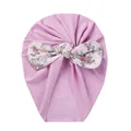 Detail of baby pink turban hat featuring a large floral bow with berry patterns - Purple Flower