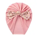 Detail of baby pink turban hat featuring a large floral daisy pattern bow for infants - Pink Floral
