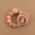 Detail of baby teething rattle with beech wood rings, silicone beads and crochet textures - Rose Pink