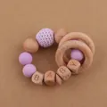 Detail of baby teething bracelet with beech wood beads, silicone beads, and BABY letter cubes - Light Purple