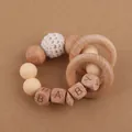 Detailed macro view of baby teether with wooden letter beads and crochet textures - Beige