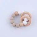 Detail of baby teether bracelet with silicone beads and natural beech wood rings - Khaki