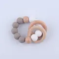 Detail of baby teething bracelet with grey silicone beads and natural beech wood rings - Dark Taupe