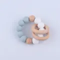 Close-up of silicone beads and natural beech wood rings on baby teething bracelet - Grey Blue