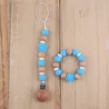 Detail of blue silicone rose teether bracelet and matching pacifier clip with wooden beads - Sky Blue