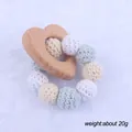 Detail of baby teething ring with wooden heart and macaron crochet beads weighing 20g - Heart Hand Bell Style (5#)