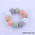 Close-up of baby teether rattle with crochet macaron beads and beech wood on plush fabric - Macaron Bead Bracelet (8#)