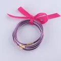 Braccialetti in silicone glitterato viola con finiture dorate e fiocco rosa - Rosso Porpora