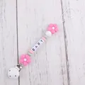 Close-up of silicone pacifier clip with pink flowers, macaron beads and BABY letter cubes - Rose Red