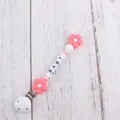 Close-up of silicone baby pacifier chain with pink flower and BABY letter beads - Watermelon red