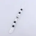 Detail of silicone baby pacifier clip with black and white beads and a zebra charm - Zebra