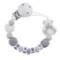 Detail of baby pacifier clip featuring white cartoon bear and silicone letter beads - White