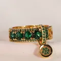 Vintage gouden ring met vijf groene edelstenen en een bijpassende smaragd micro-pave hanger - Maat 5 / Gouden Smaragdgroen