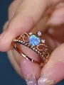 Detailed macro view of rose gold crown ring with heart-shaped blue opal and cubic zirconia - US 6 / Rose Gold Blue Opal