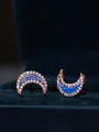 Macro detail of crescent moon earrings in rose gold finish with opal and crystals - Rose Gold Blue Opal