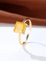 Macro shot of a square yellow gemstone set in a four-prong golden luxury ring - US 5 / Gold Yellow Zirconia