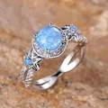 Vintage silver ring featuring a round blue opal center and delicate floral engravings - Platinum Blue Opal