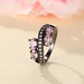 Detail of black alloy ring featuring pink oval zircons and pavé-set accent diamonds - US 6 / Black Gold Pink