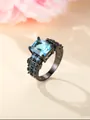 Luxurious black metal ring featuring emerald-cut blue gemstone and paved zircons - US 5 / Black Gold Aqua Blue