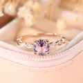 Elegant rose gold ring featuring a brilliant round pink gemstone and leaf diamond accents - US 6 / Rose Gold Pink