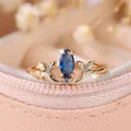 Vintage French style rose gold ring featuring a royal blue marquise gem and leaf filigree - US 6 / Champagne Gold Royal Blue